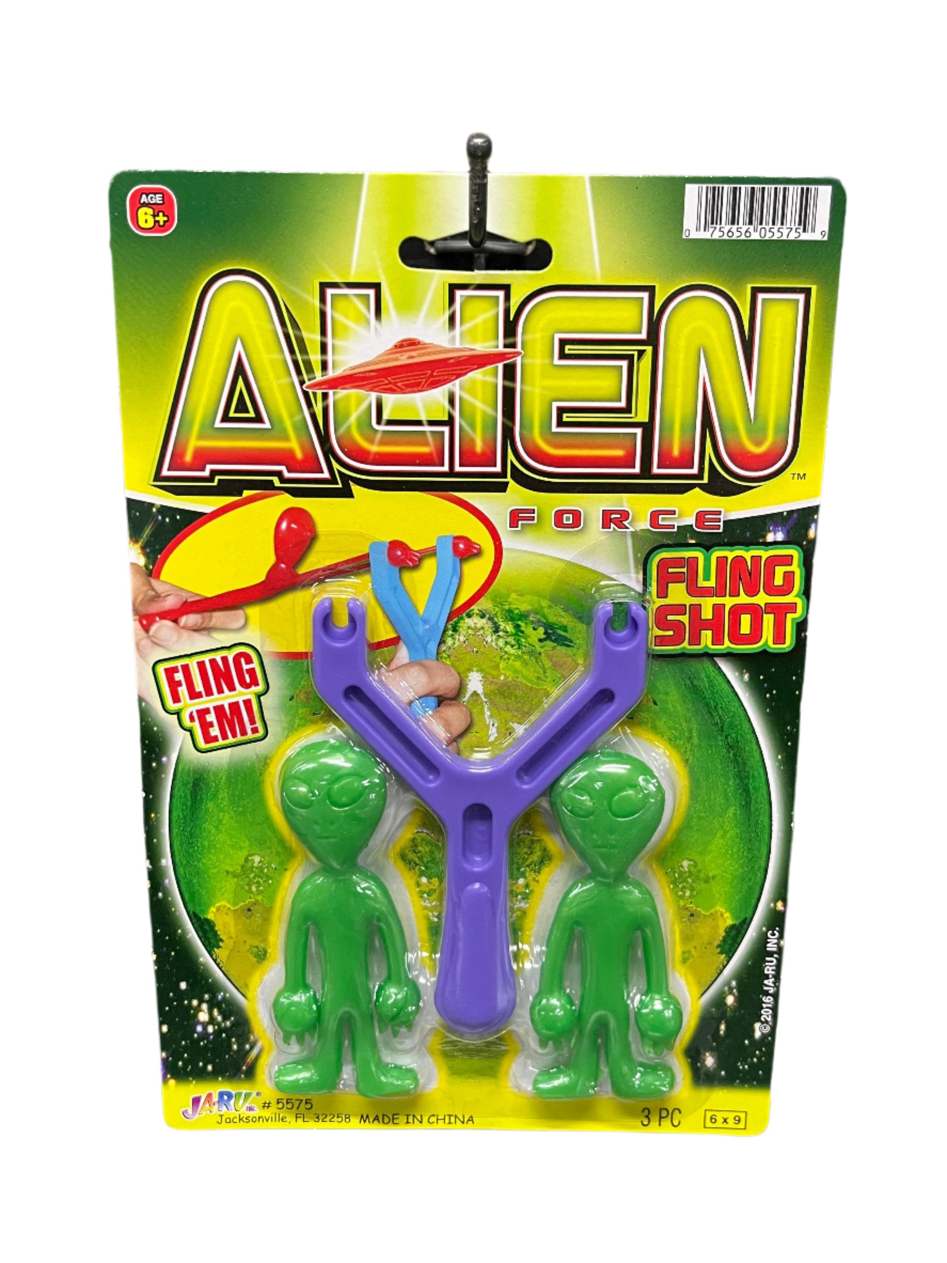 Toy fling shot with green figures on a colorful package labeled 'Alien Force' 